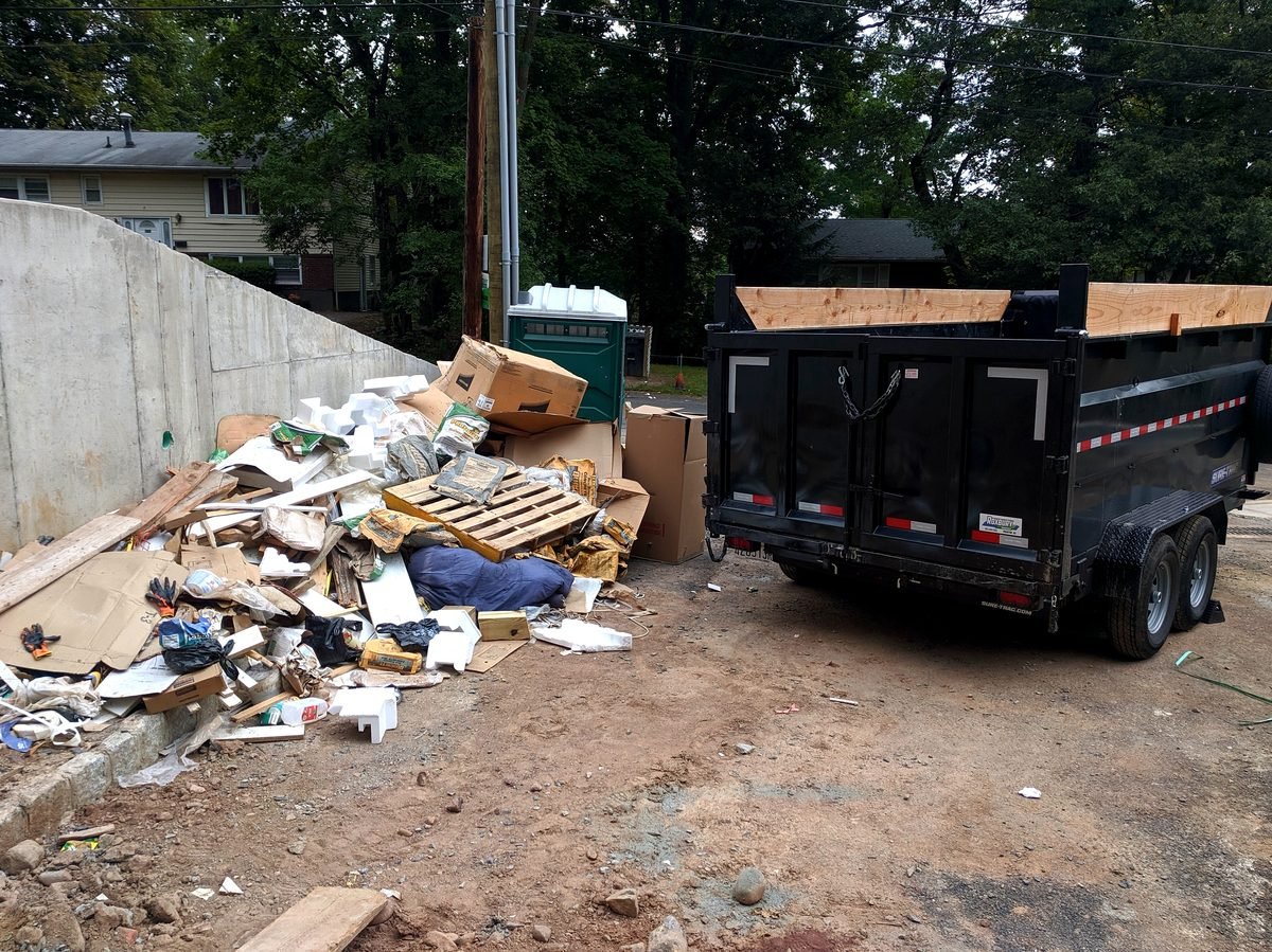 Orange Valley Environmental & Container Services roll-off delivery truck and driver operating in Orlando