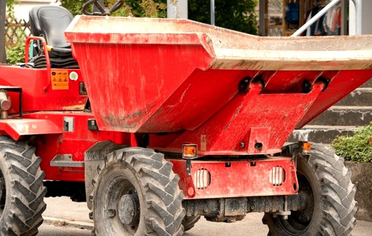 Front Range Waste & Roll-Off Services roll-off delivery truck and driver operating in Denver