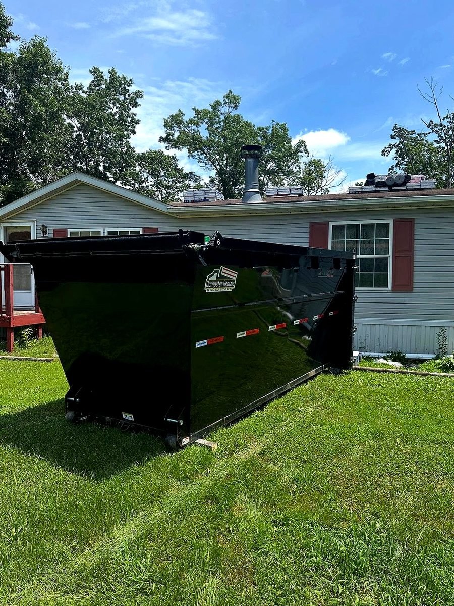 Sierra Nevada Waste & Container Services roll-off delivery truck and driver operating in Reno